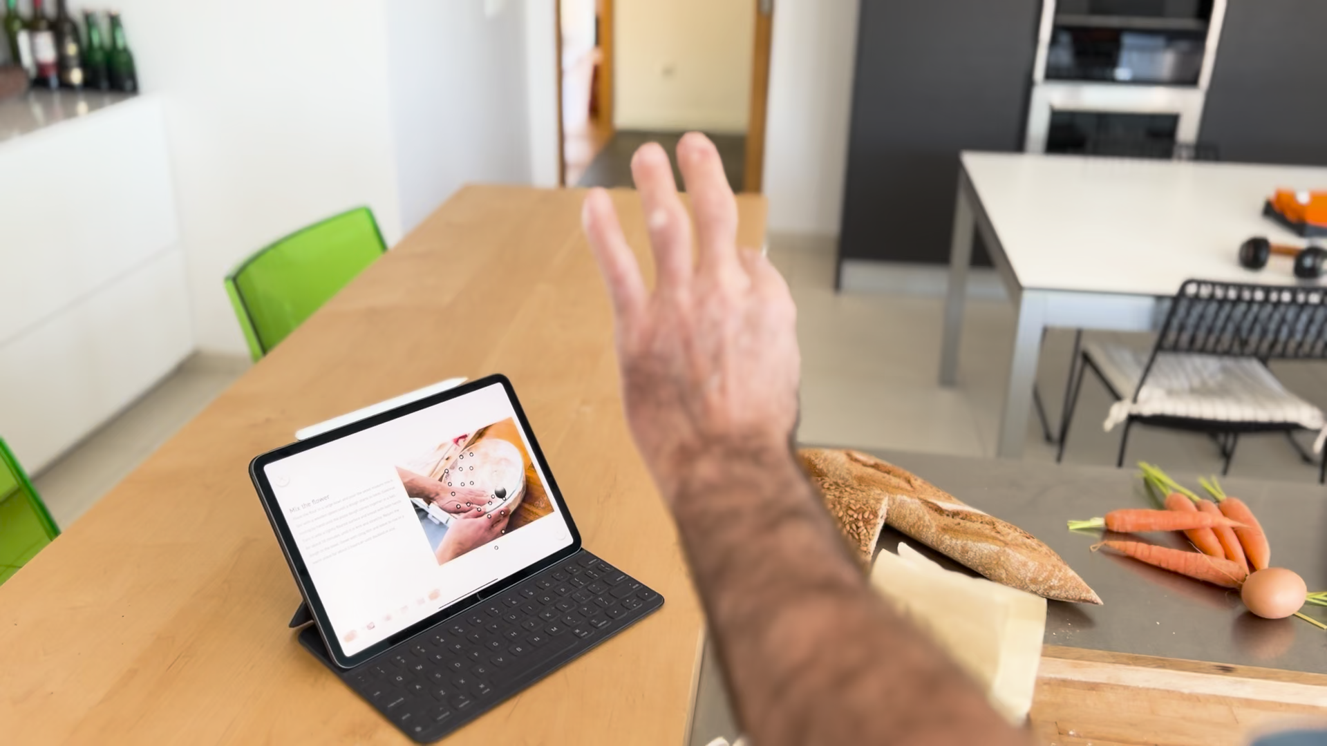 <p>A hand held in front of an iPad that is using the Sans Hands app. On the iPad the hands joints are being visualized demonstrating that you can interact with a screen from a distance using your hand.</p>