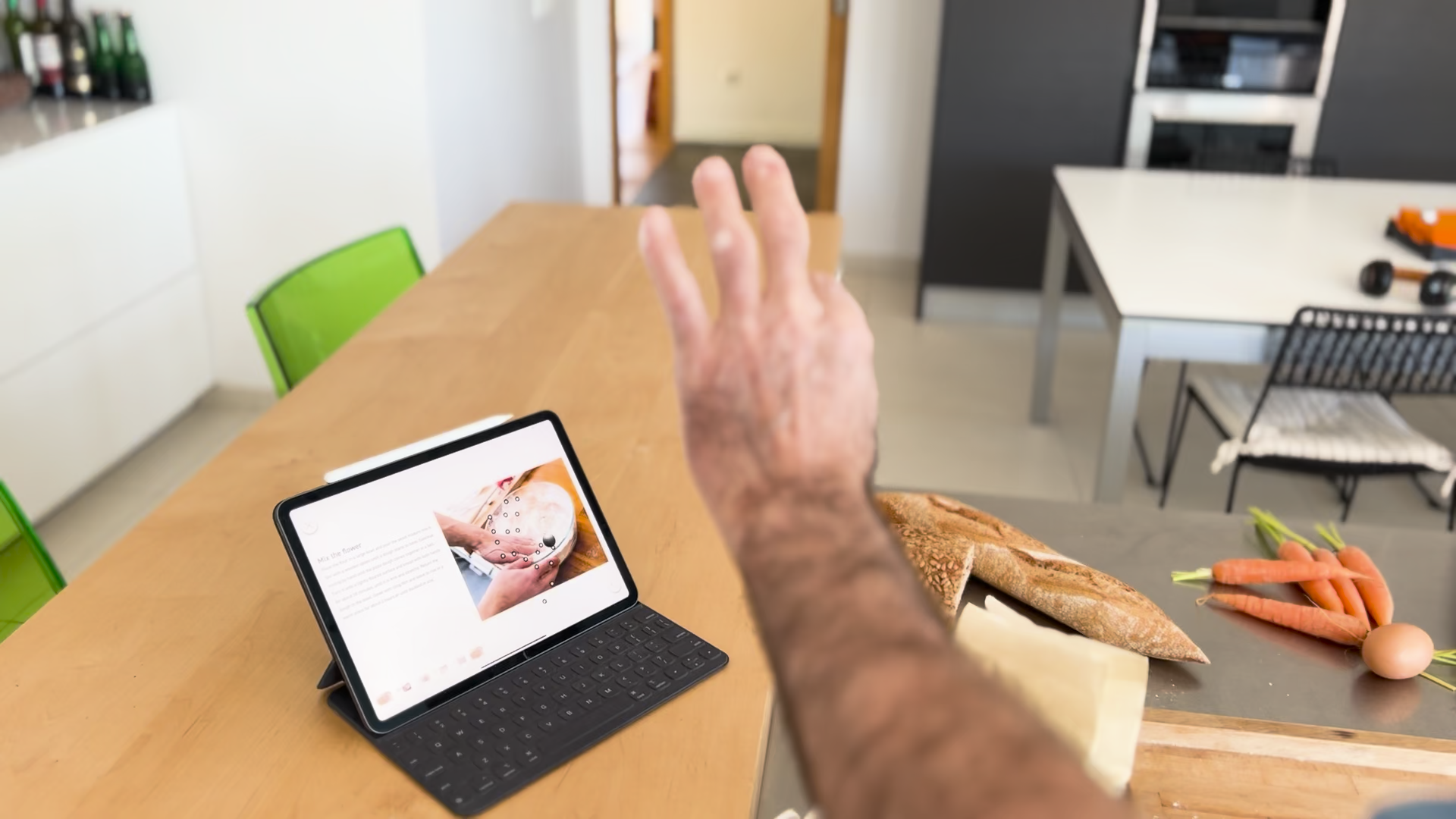 A hand held in front of an iPad that is using the Sans Hands app. On the iPad the hands joints are being visualized demonstrating that you can interact with a screen from a distance using your hand.