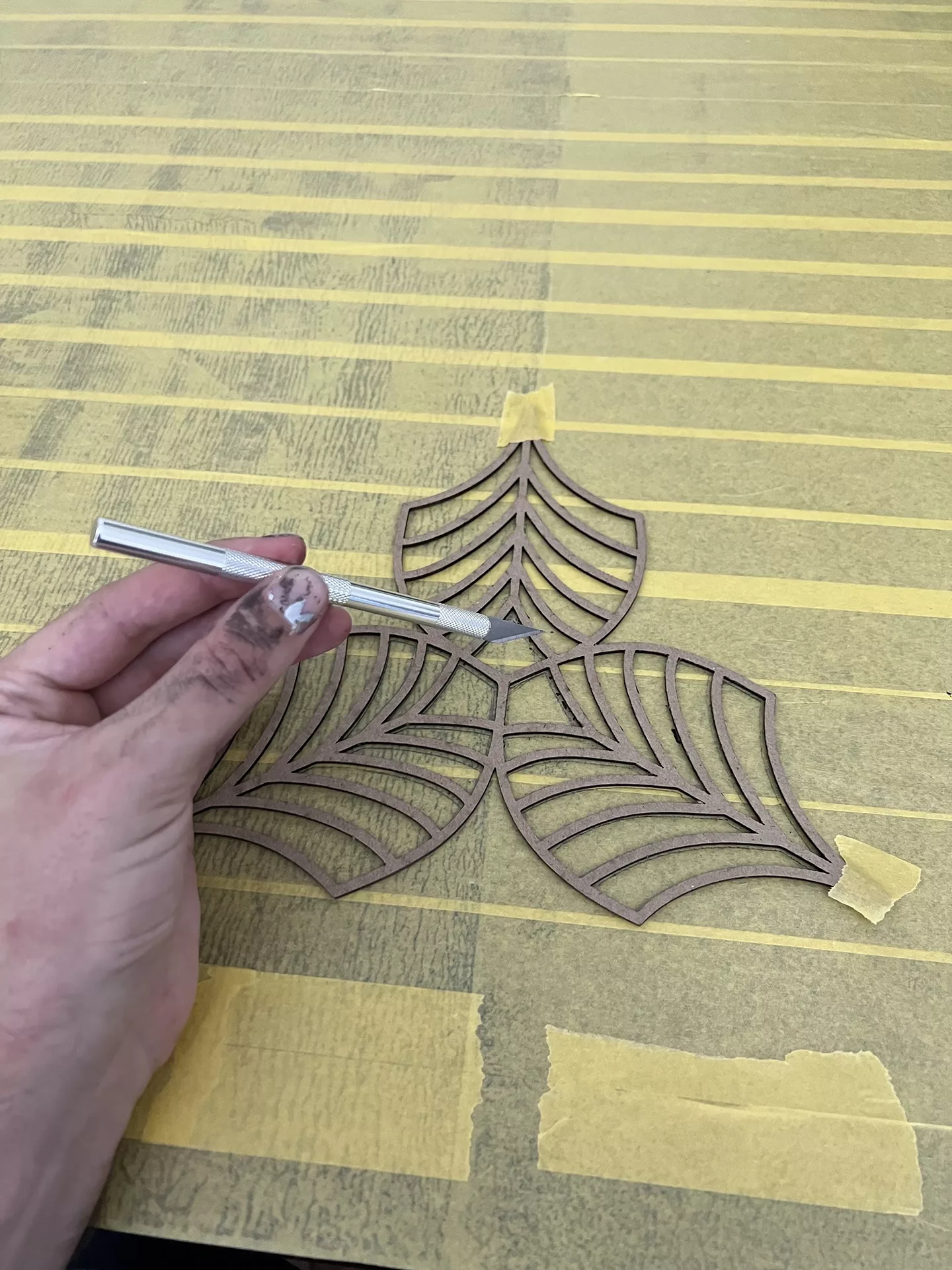We used an exacto knife, the MDF leaves and tape to create the pattern.