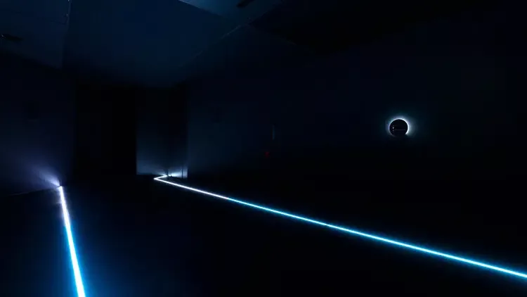 A picture of the installation, demonstrating the floor-lit environment that the user is welcomed into.