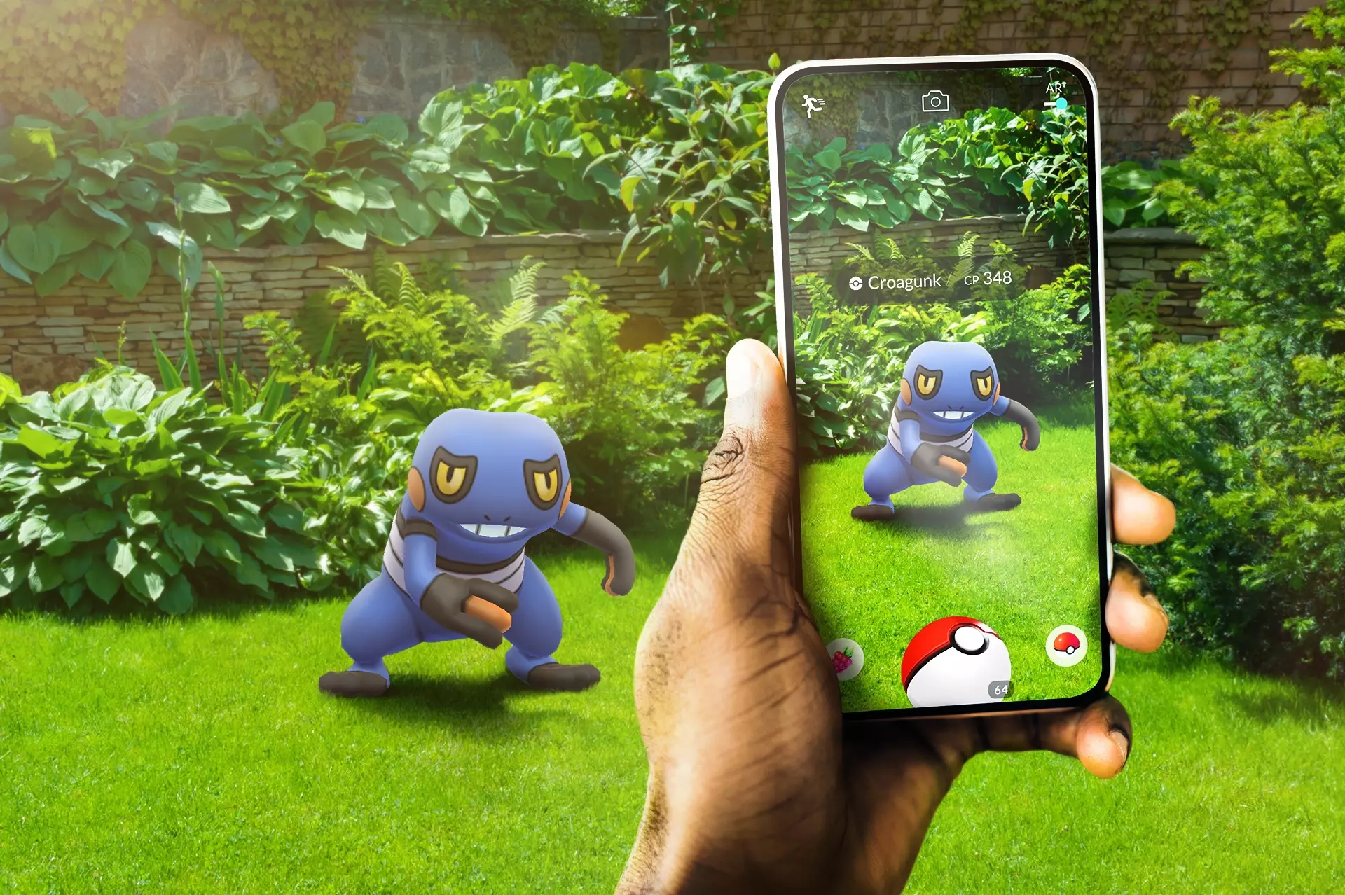An advertisement for Pokemon Go showing a Pokemon in Augmented Reality on a mobile phone screen that has a poke ball.