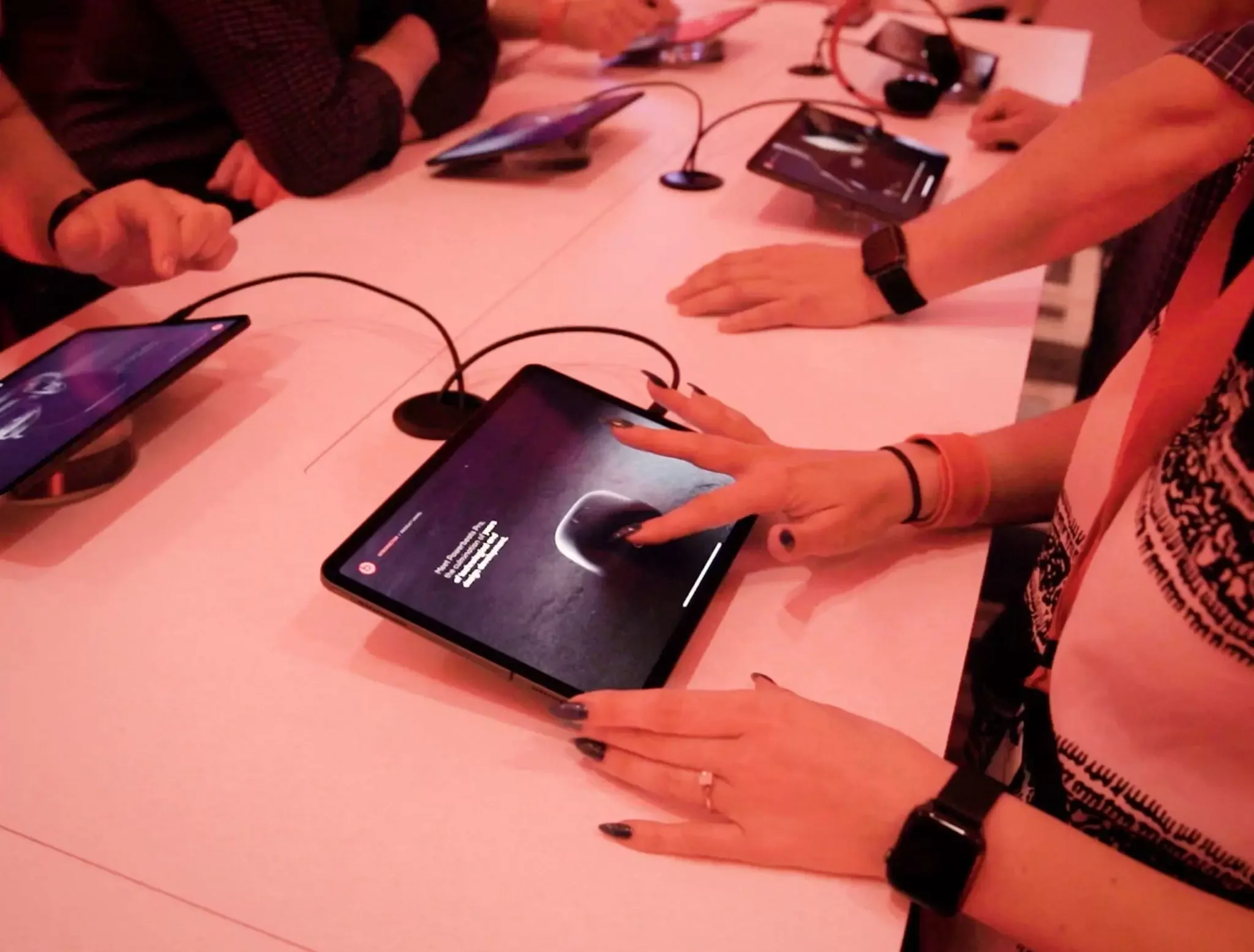 An employee opening Powerbeats Pro using Beats Tempo's interactive swipe to open.