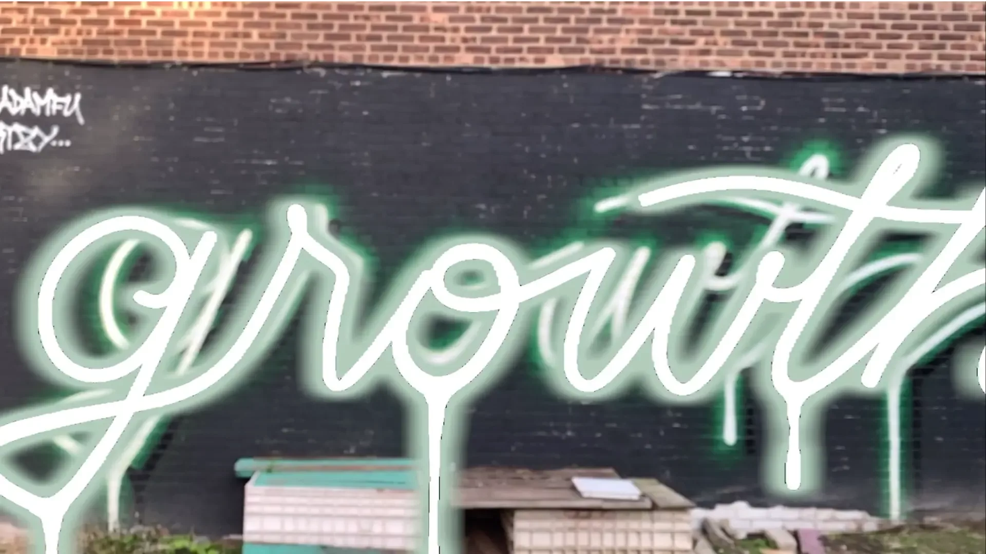 <p>A graffiti with of the word "Growth" with an augmented reality 3D model overlayed over it;. The 3D model makes use of post-processing techniques to become illuminated with green neon glow.</p>